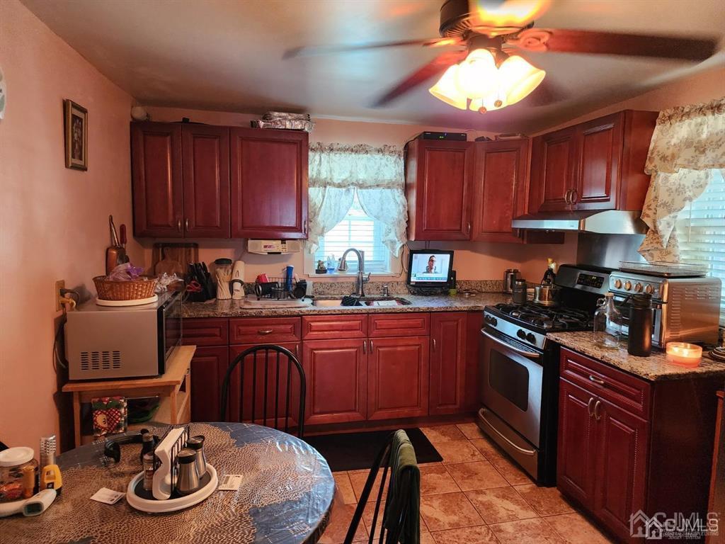 184 Raritan Street Keyport, NJ 07735 - Photo 7 of 24 a kitchen with a sink a stove and a microwave