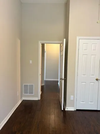 a view of hallway with wooden floor