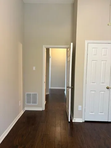 a view of hallway with wooden floor