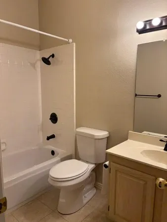 a bathroom with a toilet a sink and shower