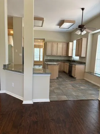 a view of kitchen with window and wooden floor