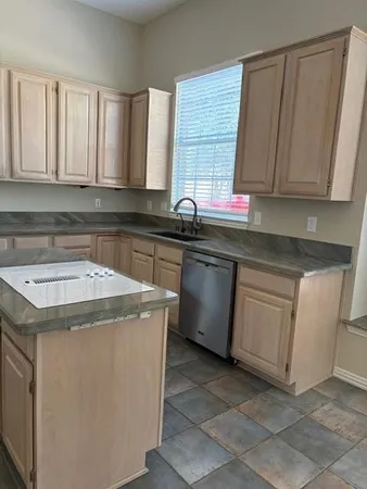 a kitchen with a sink stove and cabinets