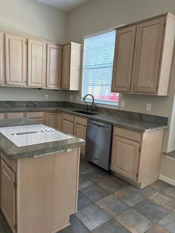 a kitchen with a sink stove and cabinets