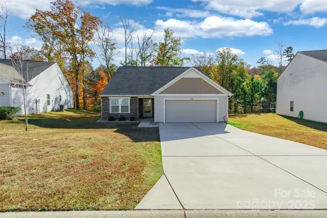 a front view of a house with a yard and trees