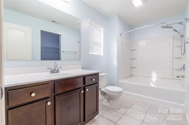 a bathroom with a sink a toilet a mirror and shower