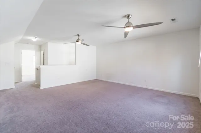 a view of a big room with closet and windows