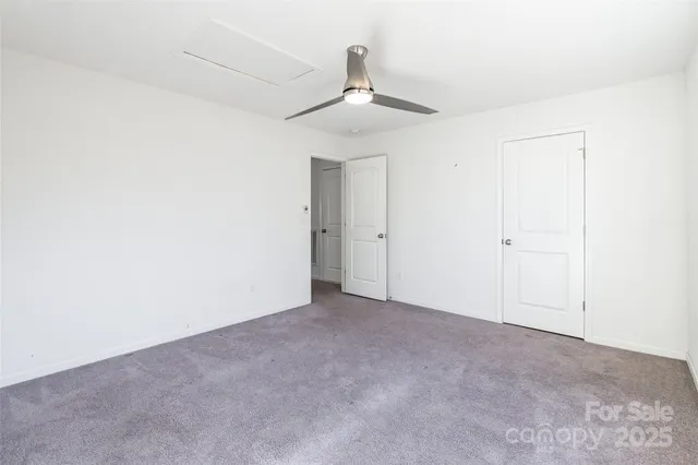 an empty room with a ceiling fan