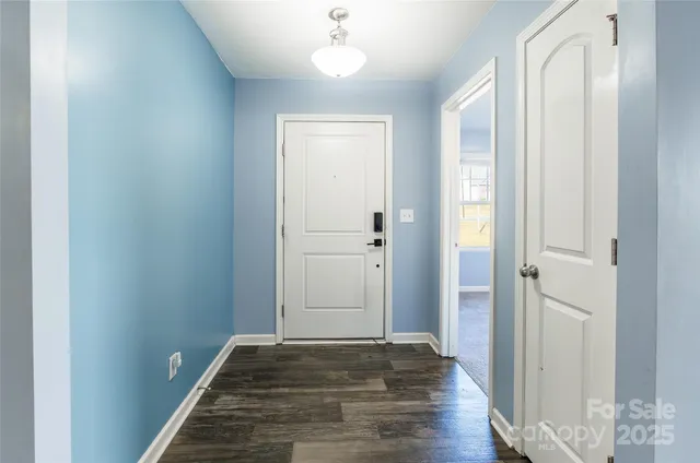 a view of a hallway with wooden floor and closet