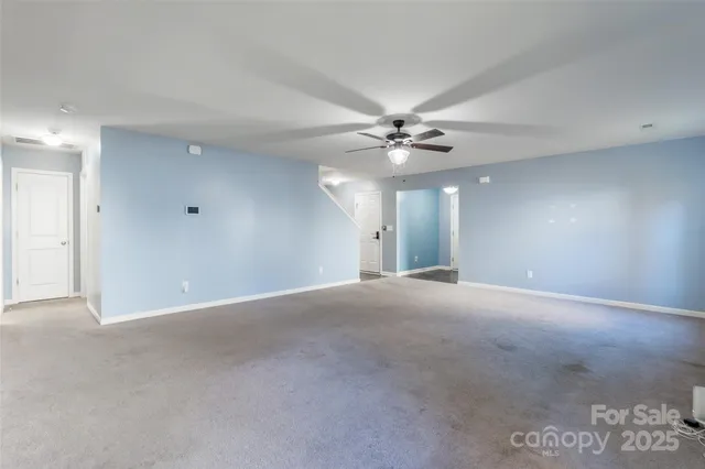 a view of an empty room with a ceiling fan