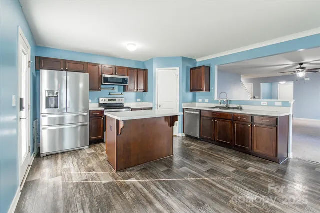 a kitchen with stainless steel appliances granite countertop a stove top oven and sink