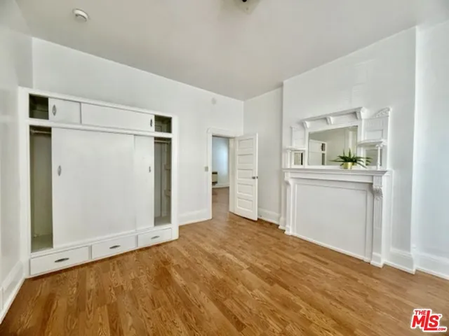 a view of a kitchen with a sink and cabinet with wooden floor