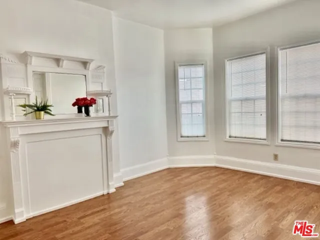 a room with a window and flowerpot