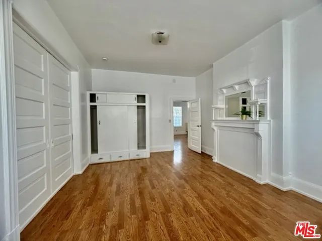 a view of a kitchen with wooden floor and a kitchen