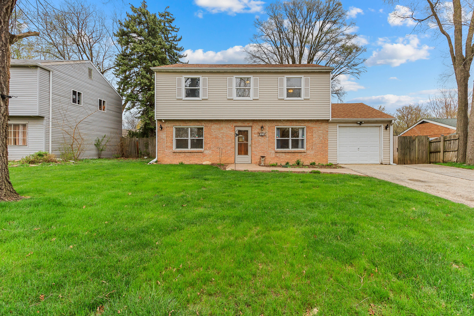 524 Spruce Road Bolingbrook, IL 60440 - Photo 1 of 33 a front view of a house with a yard and trees