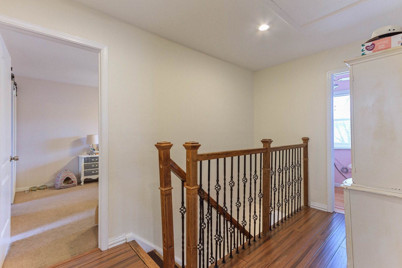 524 Spruce Road Bolingbrook, IL 60440 - Photo 16 of 33 a view of a hallway with wooden floor and a living room