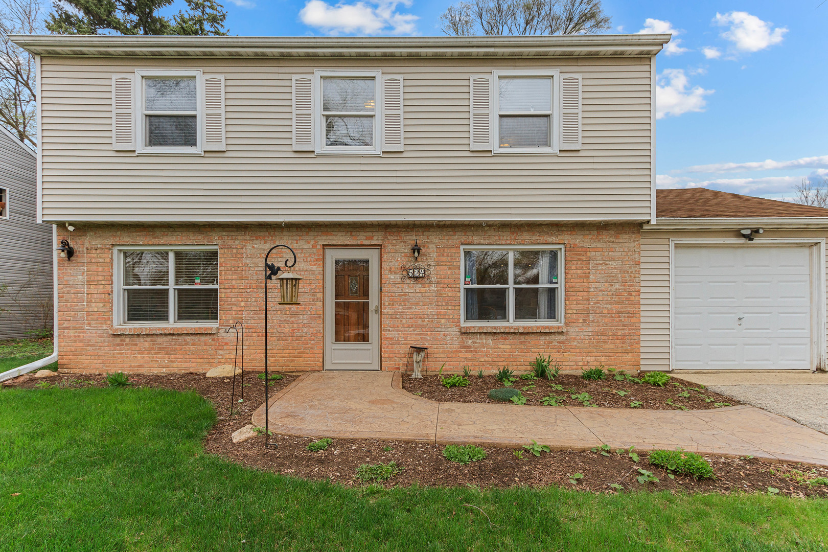 524 Spruce Road Bolingbrook, IL 60440 - Photo 3 of 33 a front view of a house with a yard