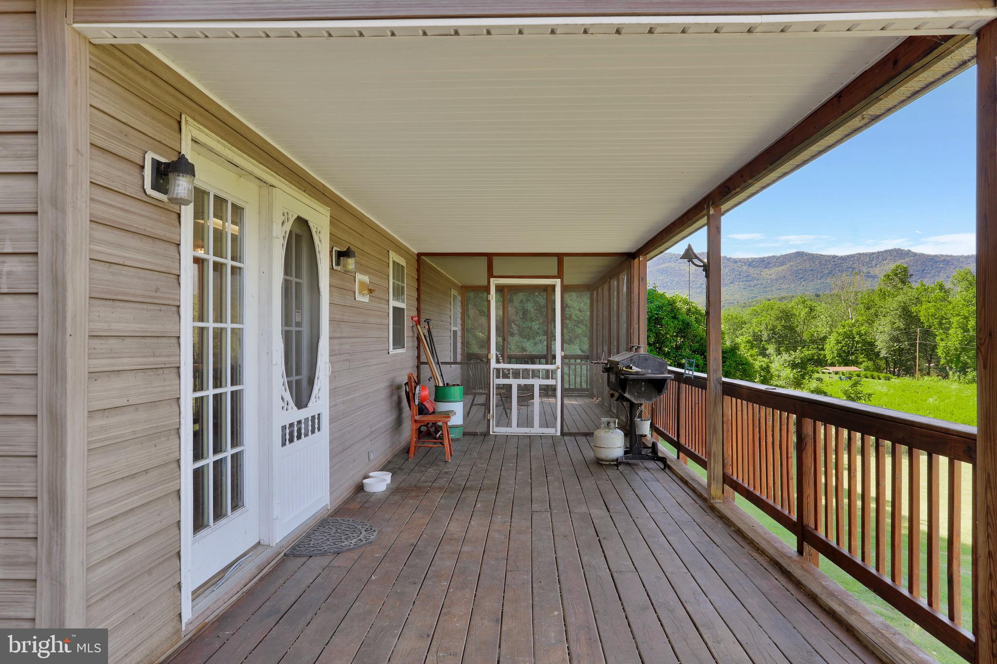 1125 Island Ford Road Rileyville, VA 22650 - Photo 30 of 70 a view of a balcony with chairs and wooden floor