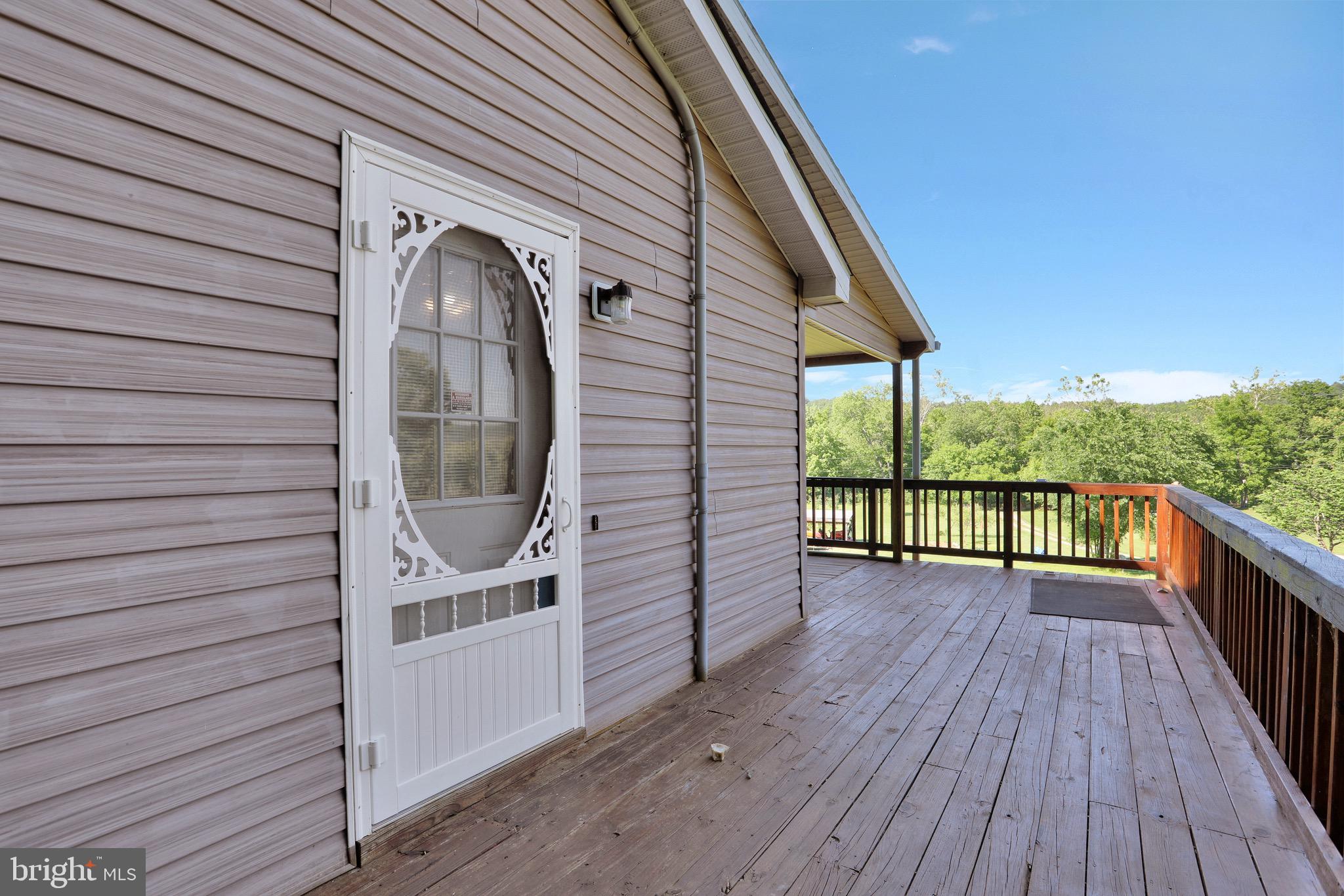 1125 Island Ford Road Rileyville, VA 22650 - Photo 33 of 70 a view of a balcony with furniture and wooden floor