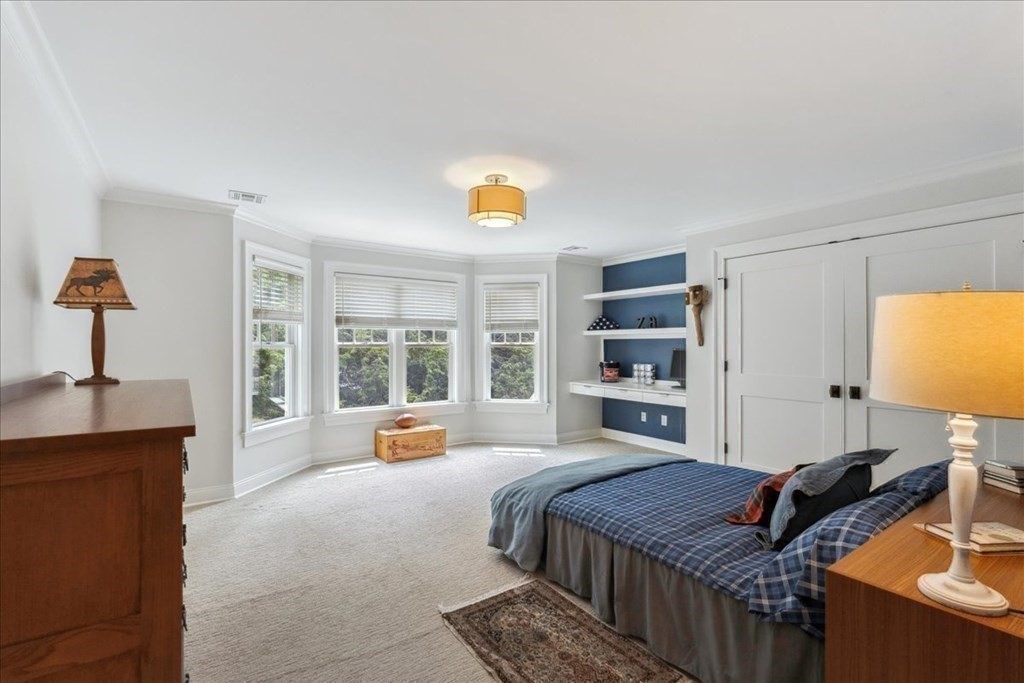 2 Decatur Lane Wayland, MA 01778 - Photo 20 of 35 a bedroom with a bed and a chandelier