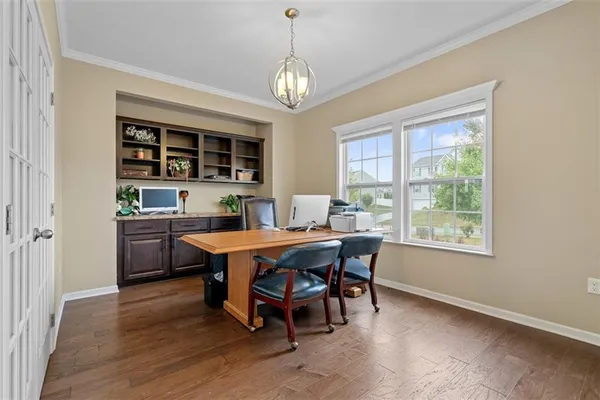 a dining room with a wooden table and chairs