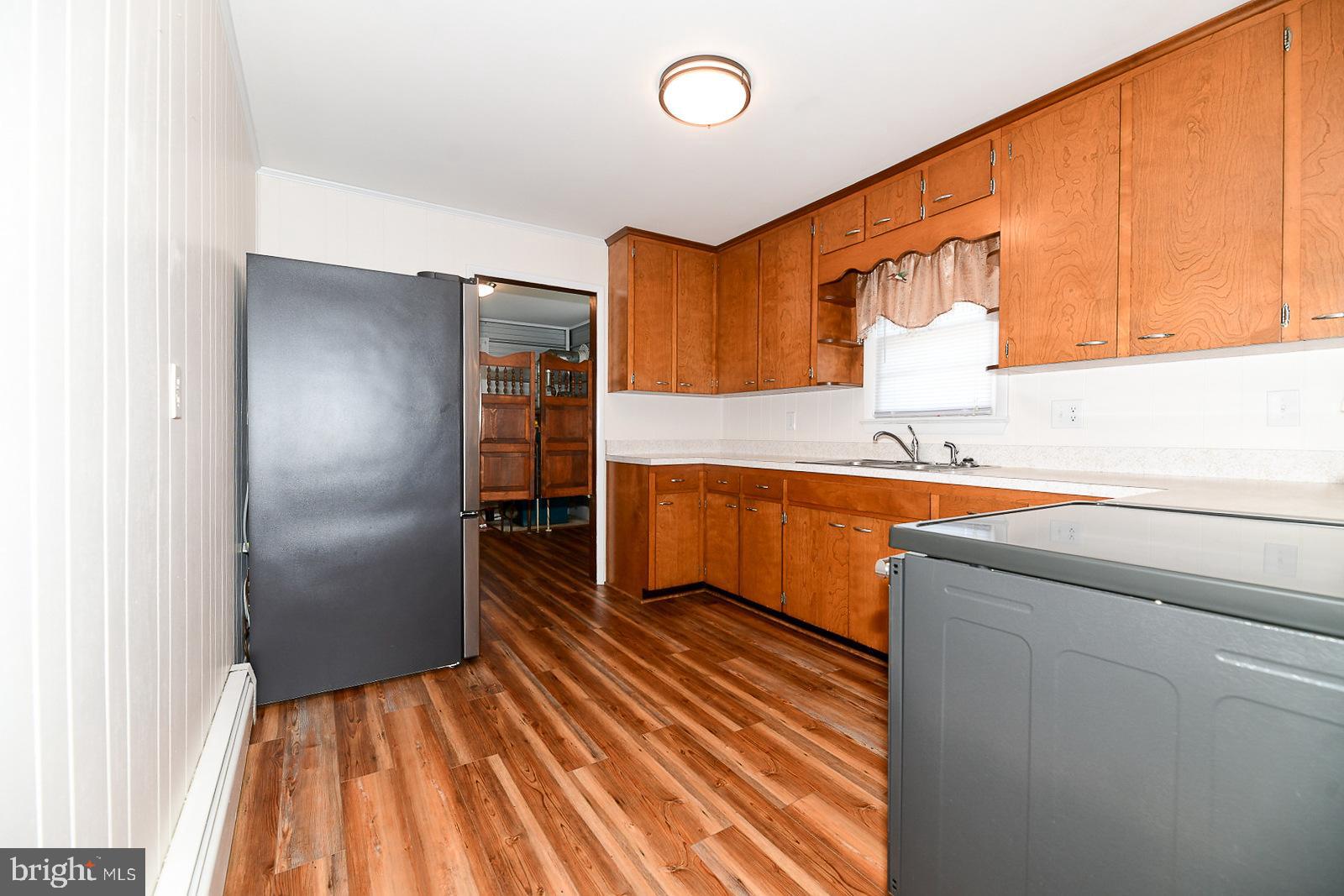 40480 Parsons Mill Road Leonardtown, MD 20650 - Photo 13 of 48 a kitchen with wooden cabinets and stainless steel appliances
