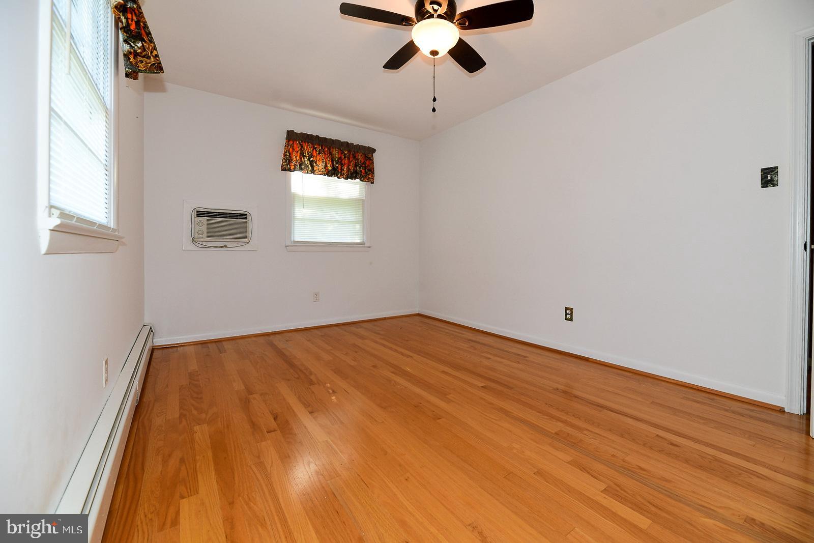 40480 Parsons Mill Road Leonardtown, MD 20650 - Photo 17 of 48 a view of a room with wooden floor and ceiling fan