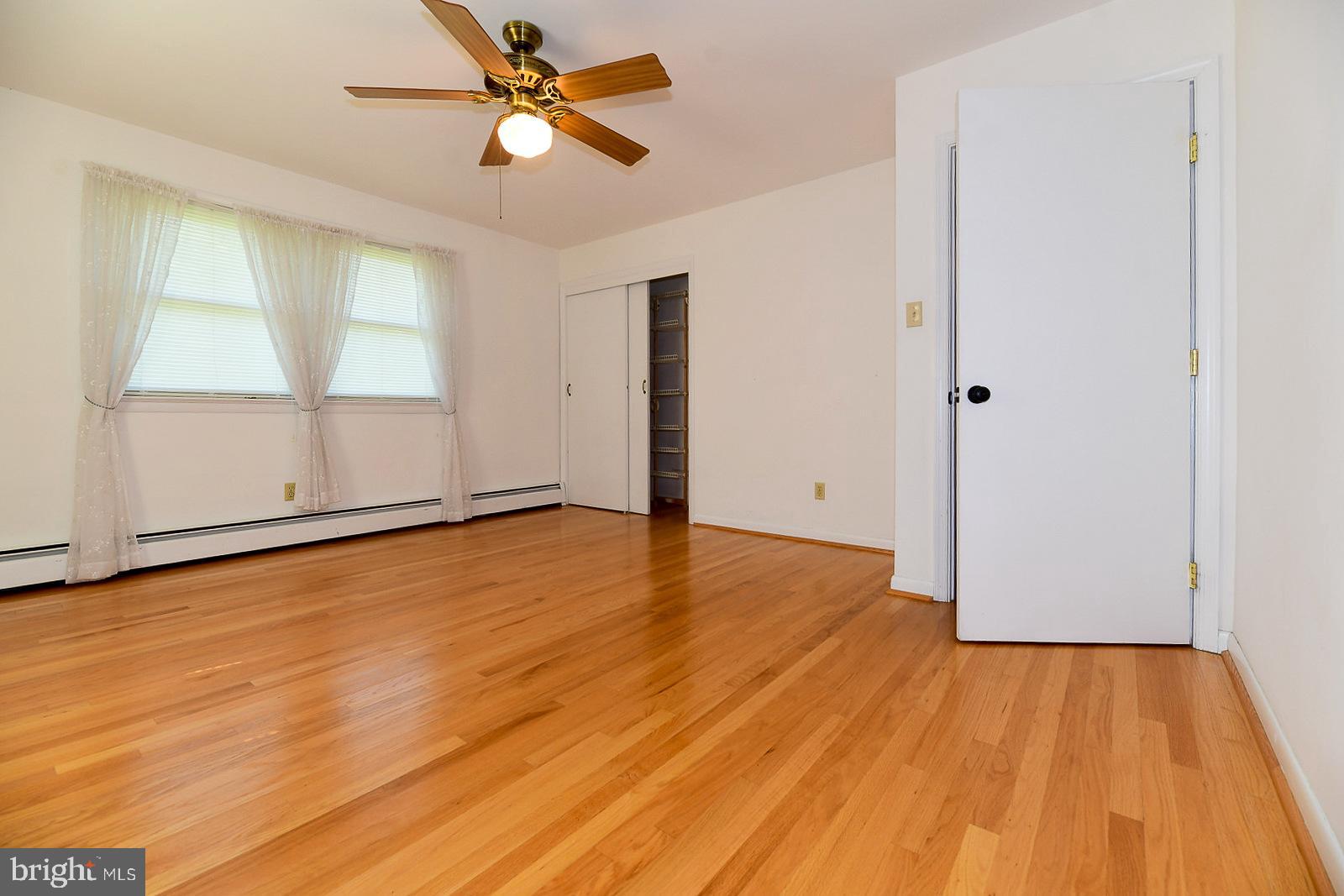 40480 Parsons Mill Road Leonardtown, MD 20650 - Photo 21 of 48 a view of empty room with wooden floor and fan