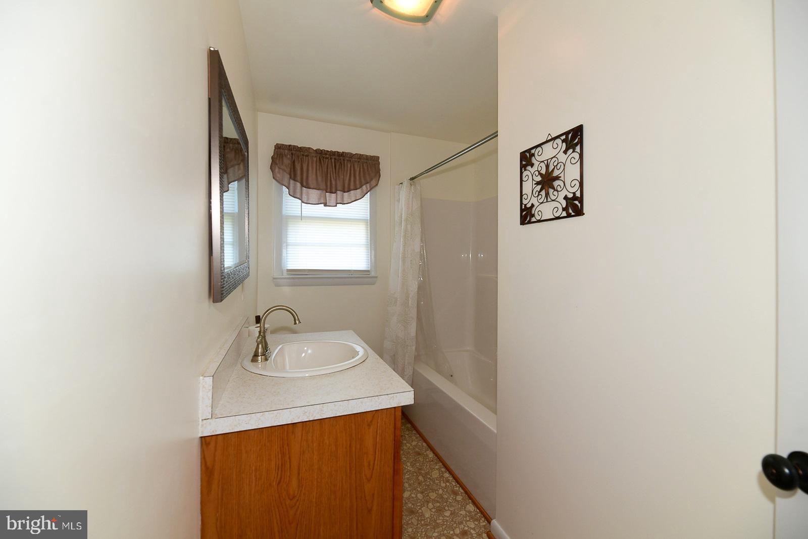 40480 Parsons Mill Road Leonardtown, MD 20650 - Photo 27 of 48 a bathroom with a sink and a mirror
