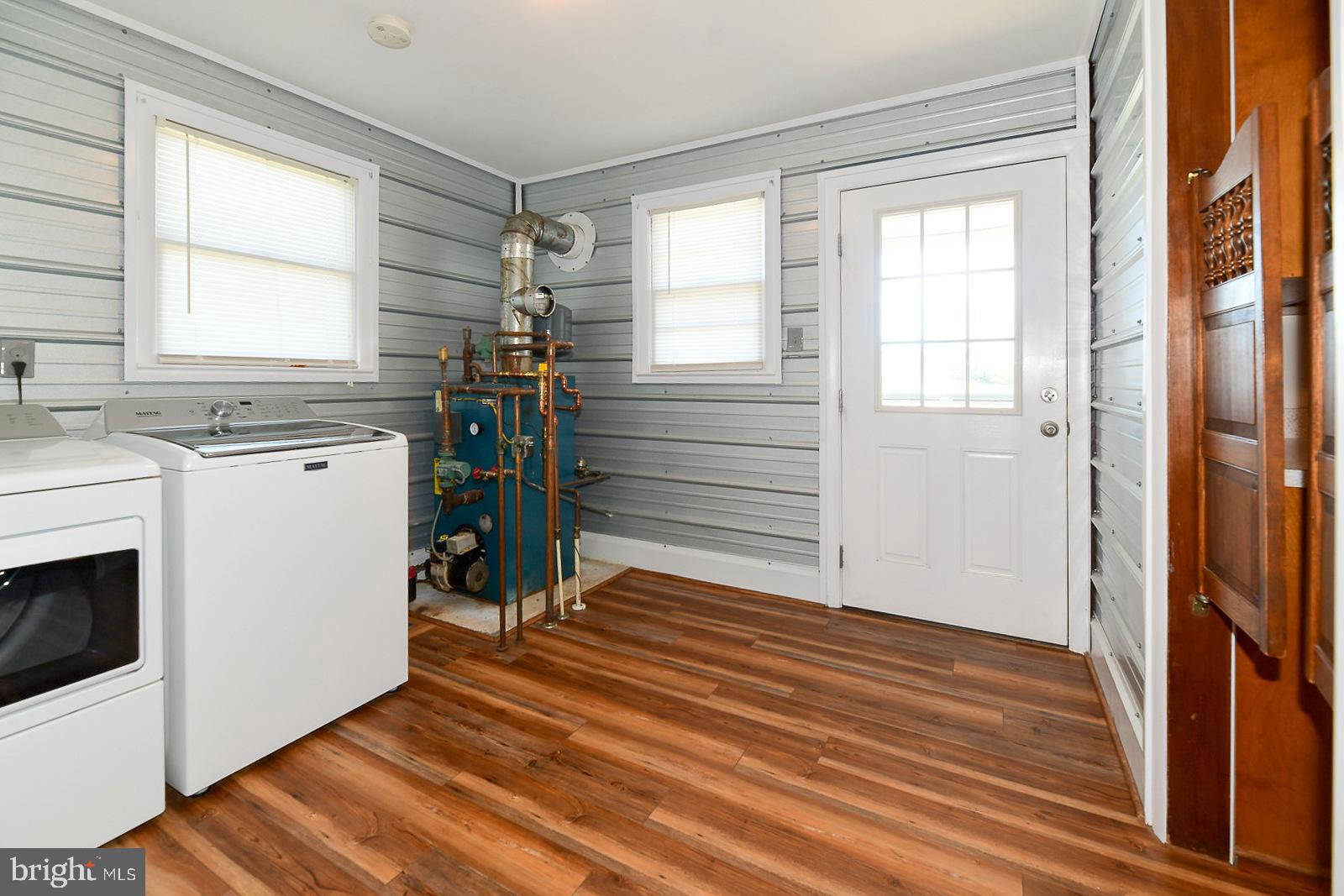 40480 Parsons Mill Road Leonardtown, MD 20650 - Photo 30 of 48 a view of a kitchen with a stove wooden floor and a window