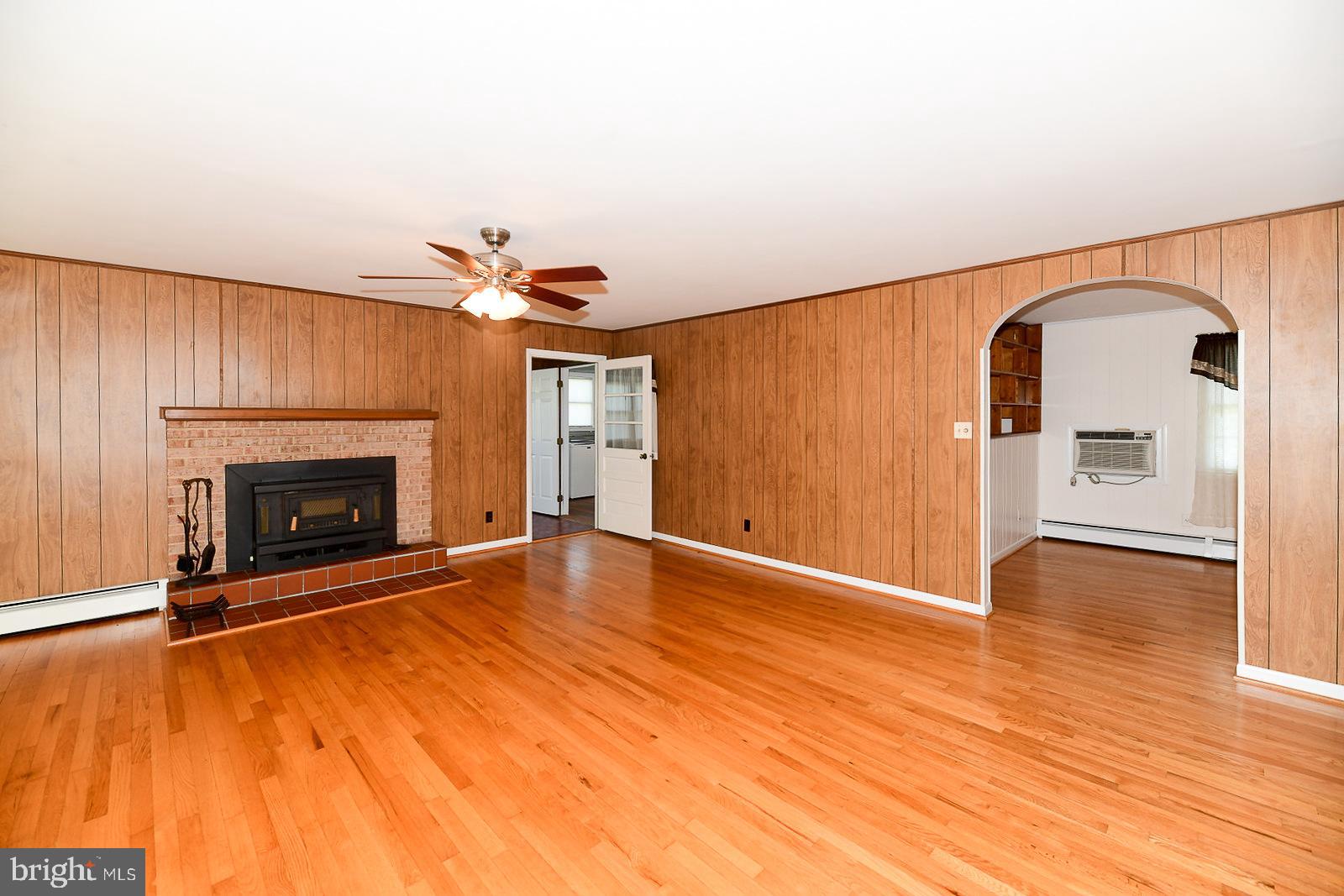 40480 Parsons Mill Road Leonardtown, MD 20650 - Photo 4 of 48 a view of empty room with wooden floor and fireplace