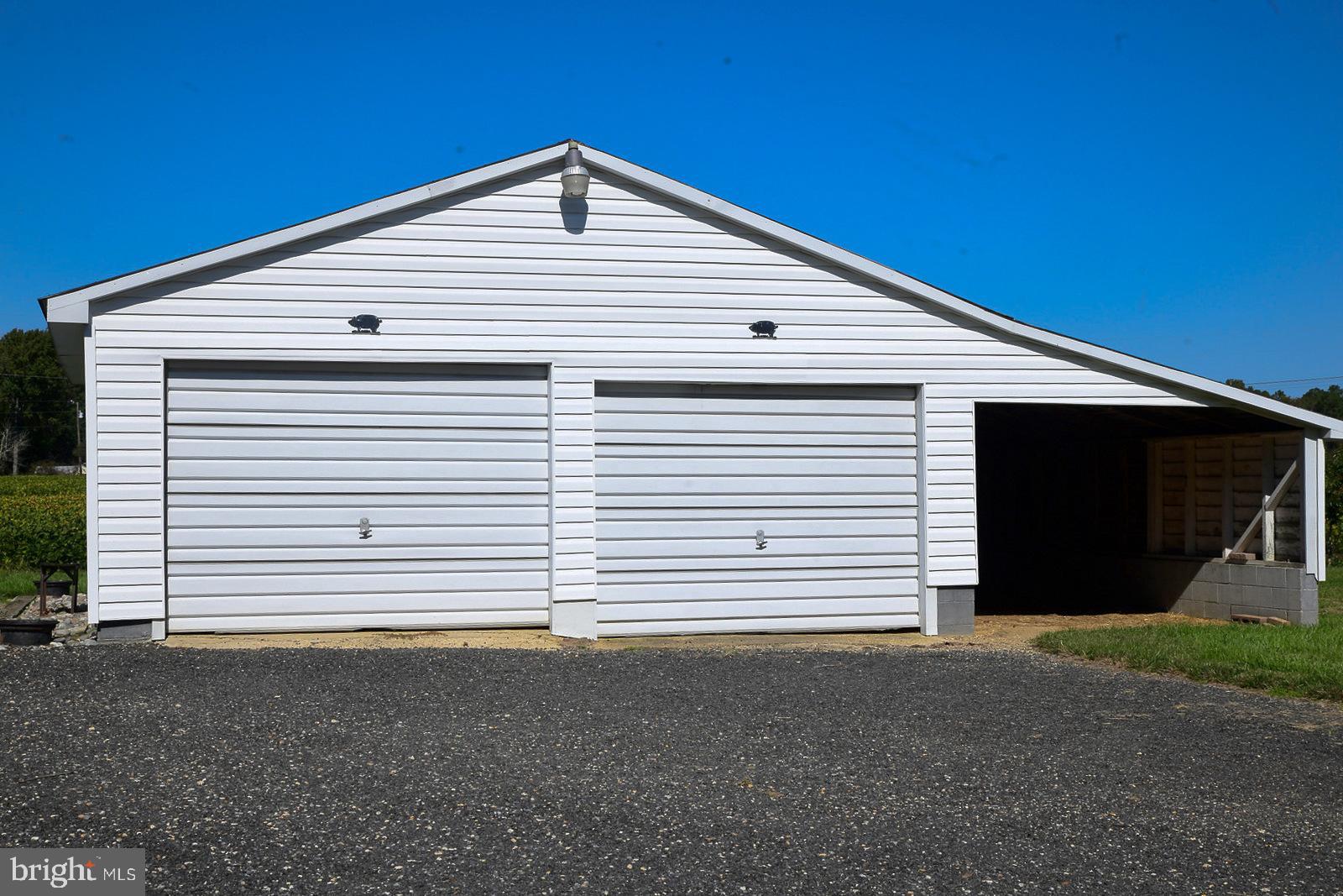 40480 Parsons Mill Road Leonardtown, MD 20650 - Photo 43 of 48 a front view of a house with a yard and garage