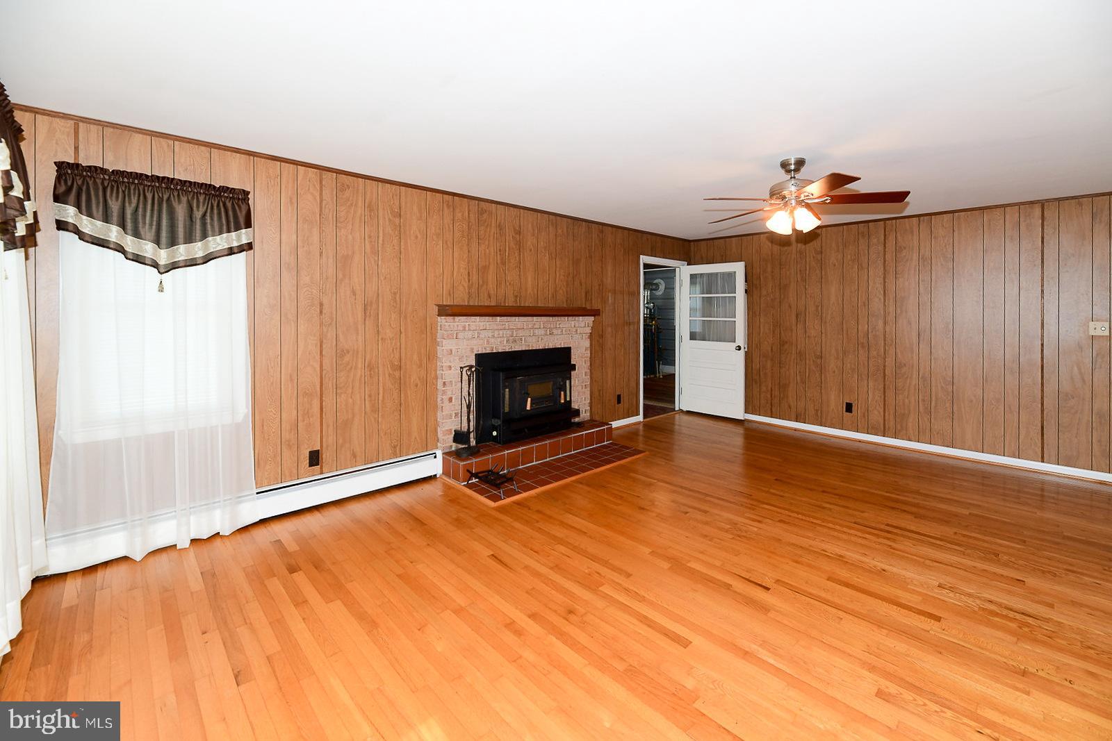 40480 Parsons Mill Road Leonardtown, MD 20650 - Photo 7 of 48 a view of an empty room with window and fire place