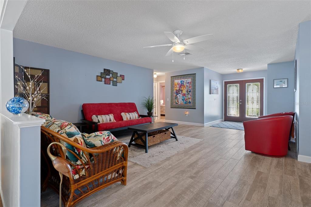 2643 Royal Ridge Drive Spring Hill, FL 34606 - Photo 12 of 84 a living room with furniture and a wooden floor