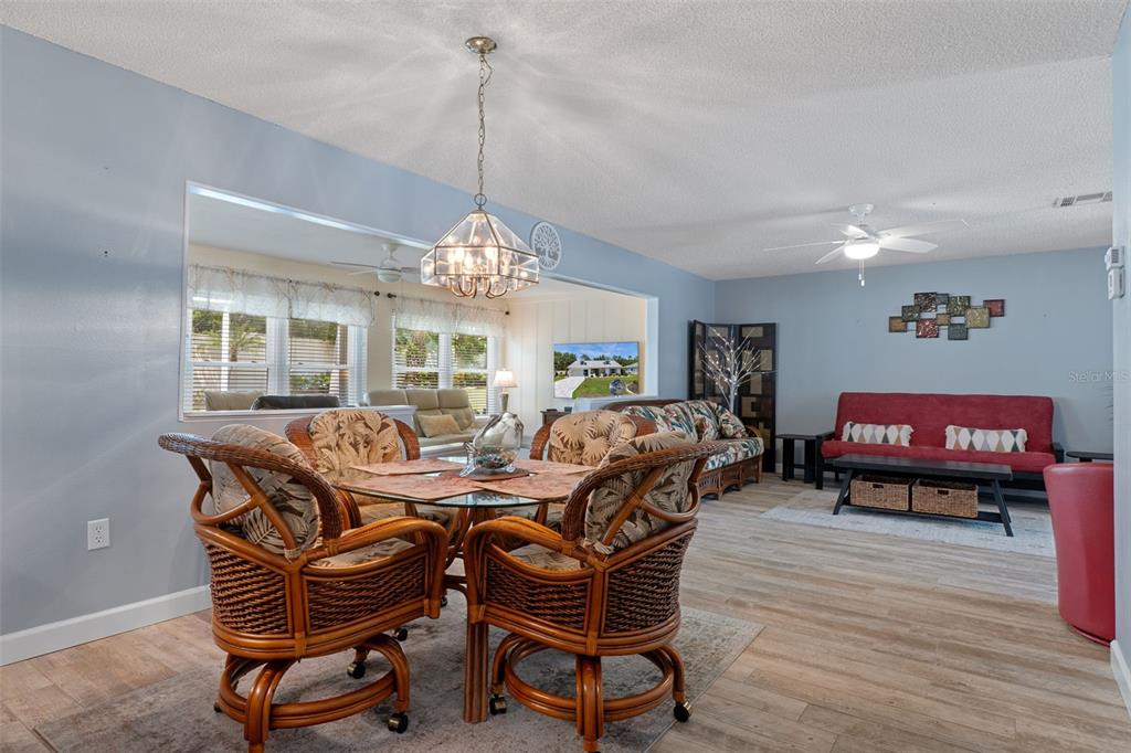 2643 Royal Ridge Drive Spring Hill, FL 34606 - Photo 14 of 84 a living room with furniture a window and a chandelier