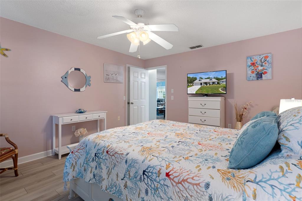 2643 Royal Ridge Drive Spring Hill, FL 34606 - Photo 29 of 84 a bedroom with a bed and a chandelier
