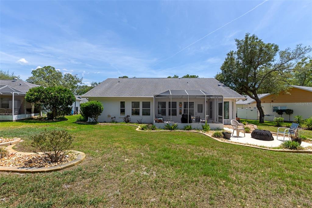 2643 Royal Ridge Drive Spring Hill, FL 34606 - Photo 38 of 84 a front view of a house with a garden and patio