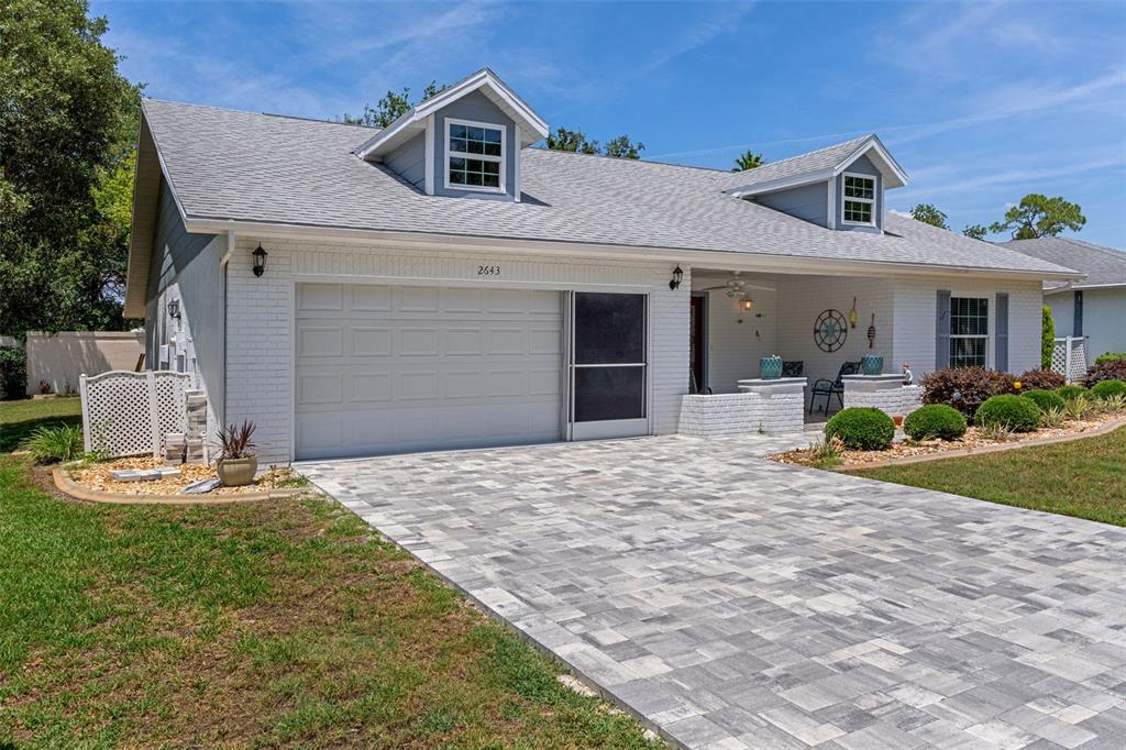 2643 Royal Ridge Drive Spring Hill, FL 34606 - Photo 4 of 84 a front view of a house with a yard