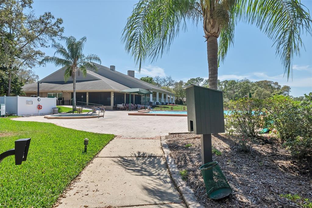 2643 Royal Ridge Drive Spring Hill, FL 34606 - Photo 58 of 84 a swimming pool with outdoor seating and yard