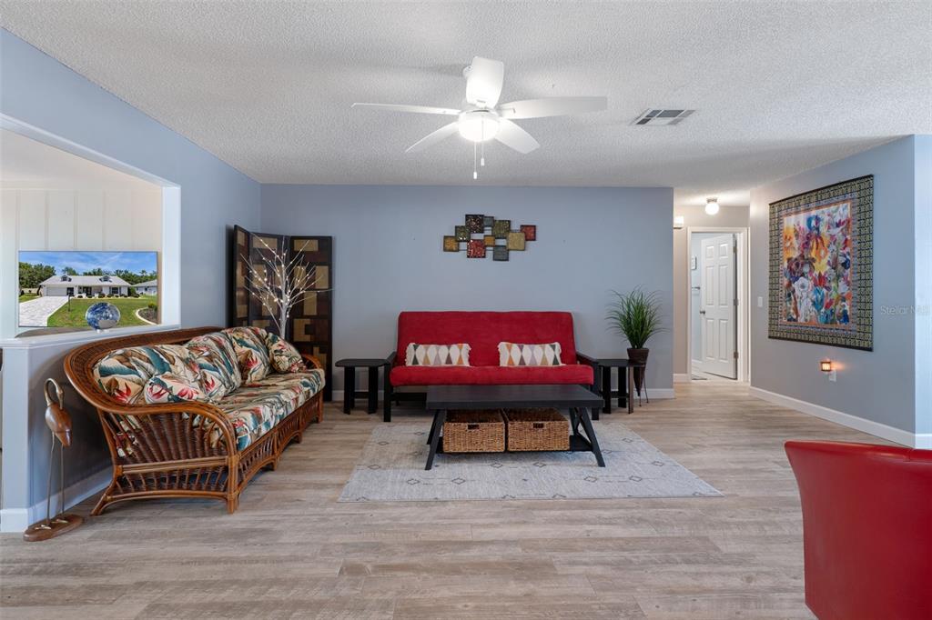 2643 Royal Ridge Drive Spring Hill, FL 34606 - Photo 10 of 84 a living room with furniture a rug and a painting