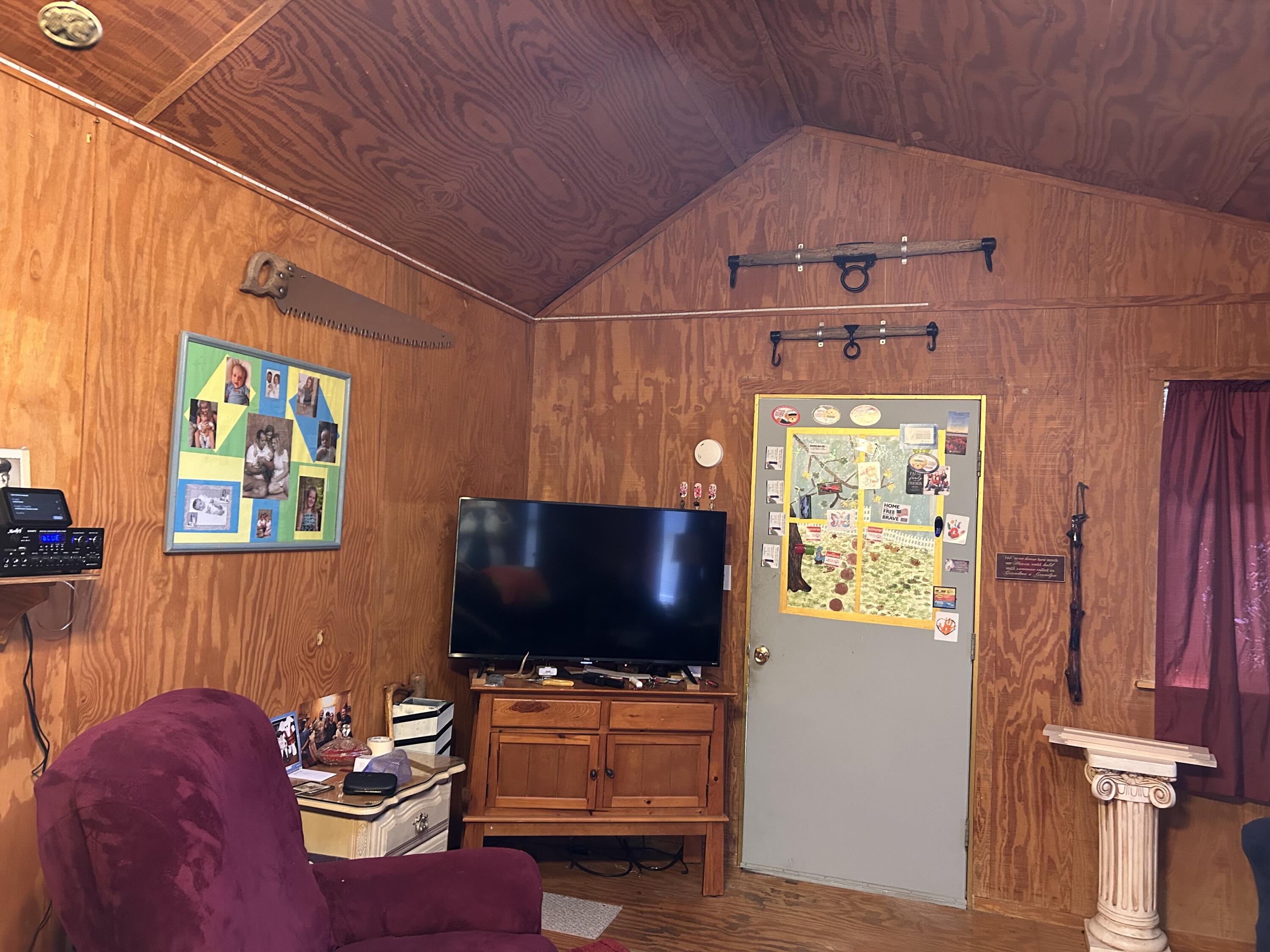 6853 Preston Posey Road Baker, FL 32531 - Photo 2 of 12 a living room with furniture and a flat screen tv