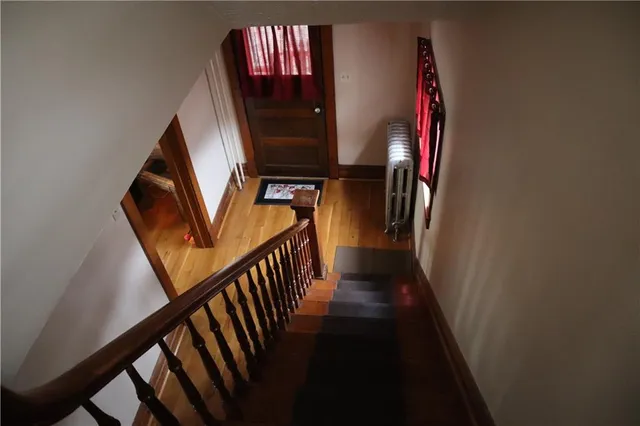 a view of stairs and hall with wooden floor