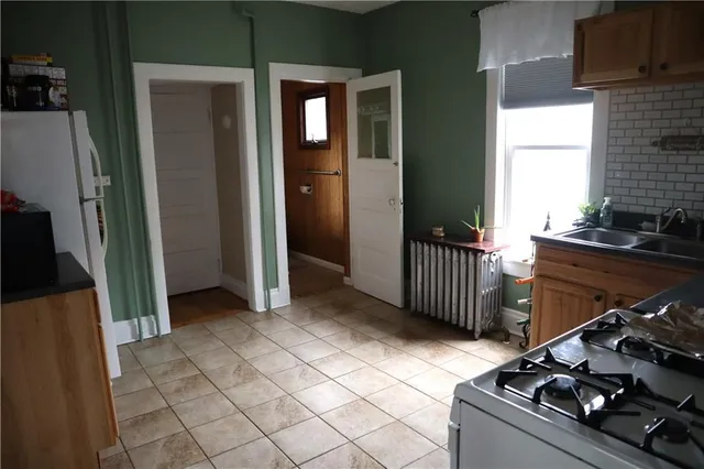 a kitchen with a stove and a refrigerator