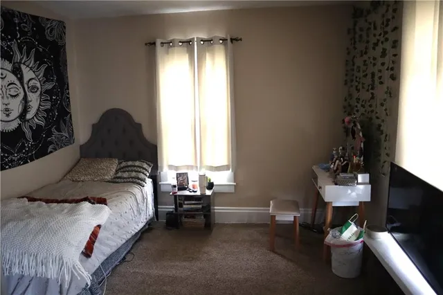 a bedroom with bed and a window