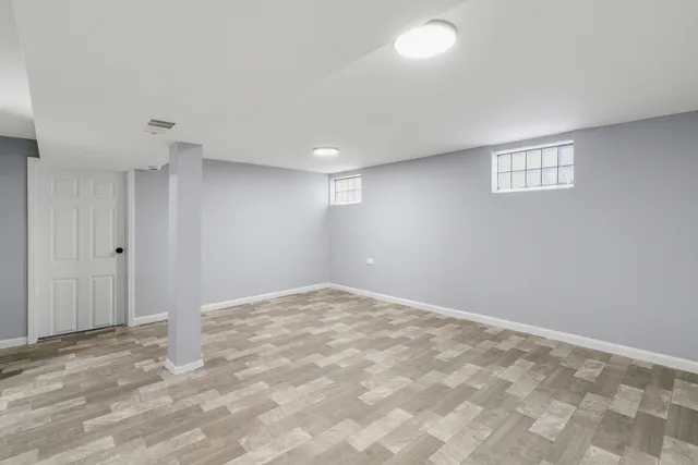 a view of wooden floor and windows in a room