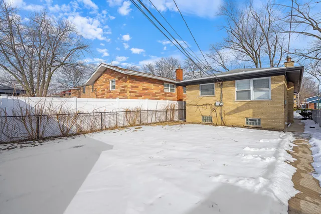 a yellow house with trees in front of it