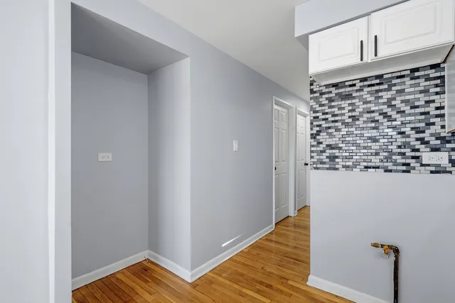 a view of a closet area with wooden floor