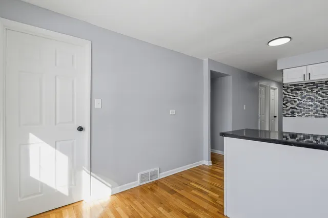 a view of a kitchen cabinets and wooden floor