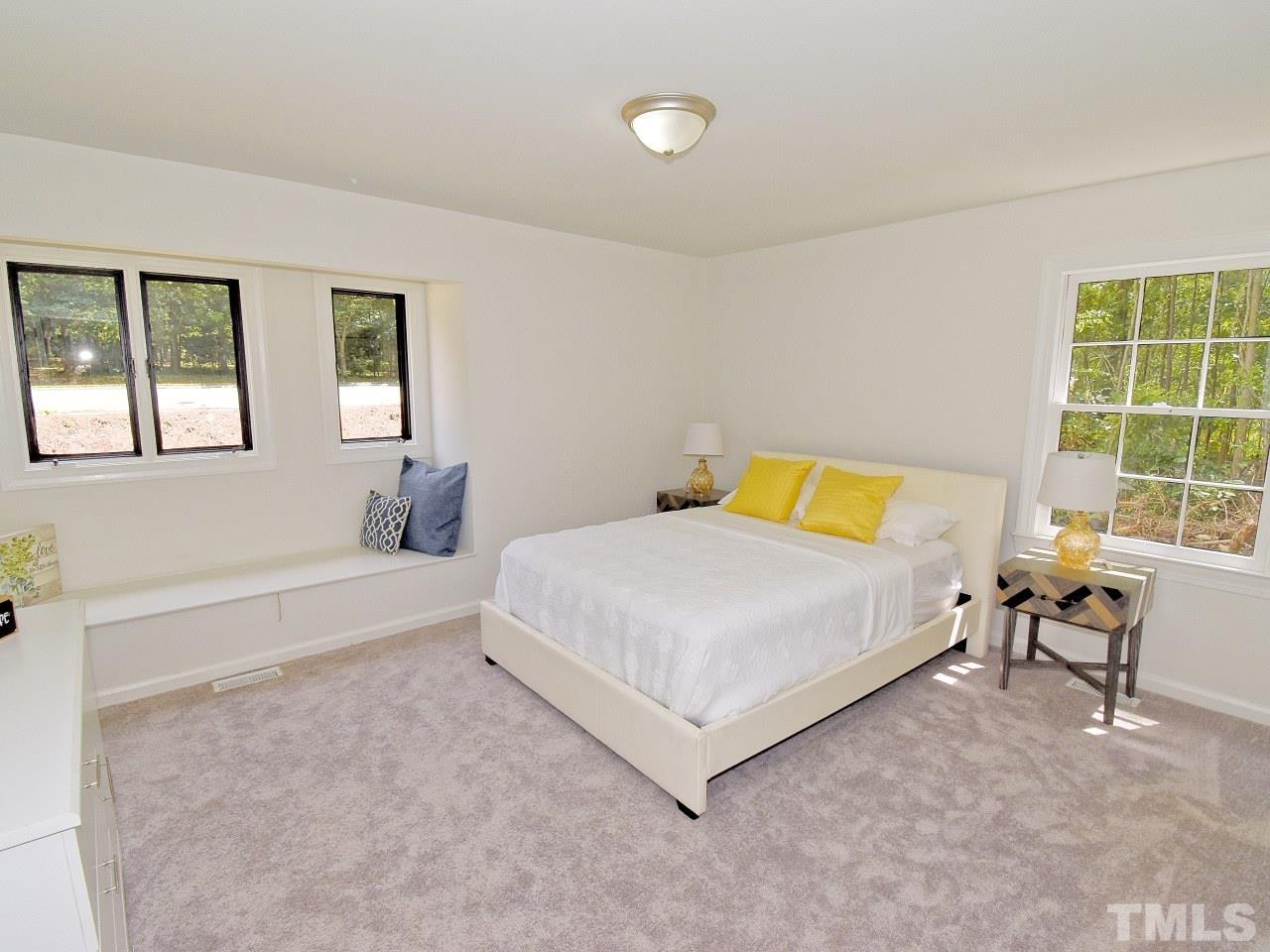 6530 Jean Drive Raleigh, NC 27612 - Photo 16 of 32 a bedroom with a bed and a table