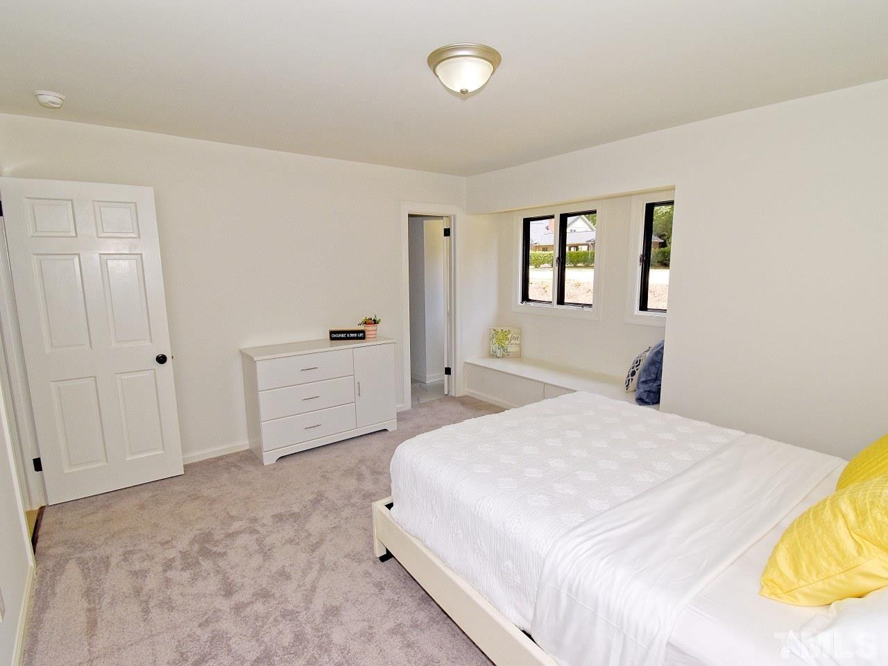 6530 Jean Drive Raleigh, NC 27612 - Photo 17 of 32 a bedroom with a bed and a window