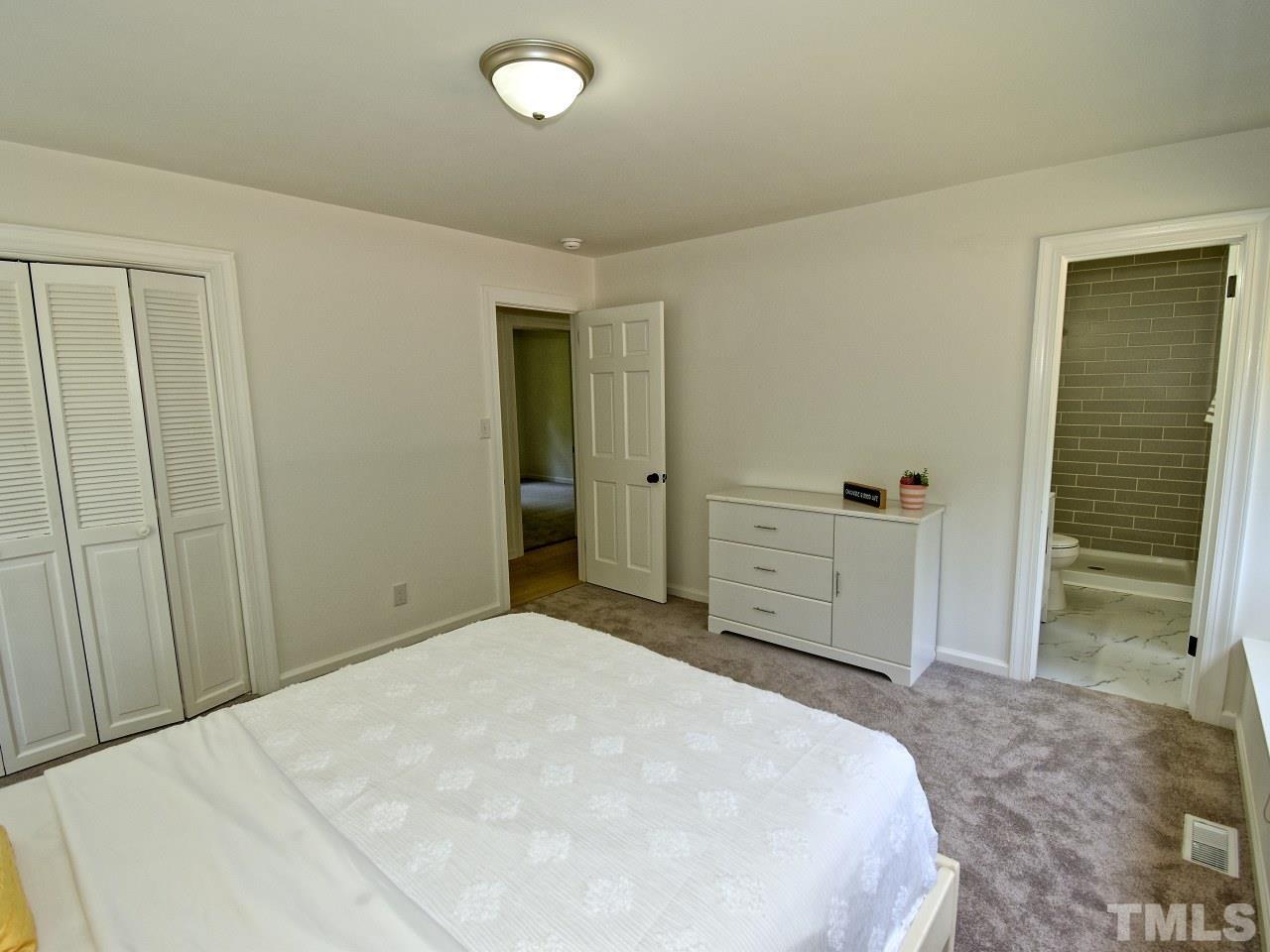 6530 Jean Drive Raleigh, NC 27612 - Photo 18 of 32 a bedroom with a bed and a bathroom
